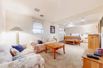 a living room with a couch and a table at Big Boulder Base Camp in Lake Harmony