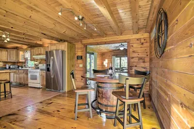 a kitchen with a bar in a log cabin at Pool, Games and Sauna Mount Joy Countryside Cabin in Mount Joy