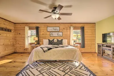 a bedroom with a bed and a ceiling fan at Pool, Games and Sauna Mount Joy Countryside Cabin in Mount Joy