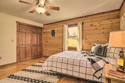 a bedroom with a bed and a ceiling fan at Pool, Games and Sauna Mount Joy Countryside Cabin in Mount Joy