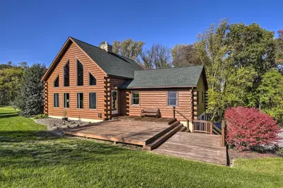 a log cabin with a wooden deck in the yard at Pool, Games and Sauna Mount Joy Countryside Cabin in Mount Joy