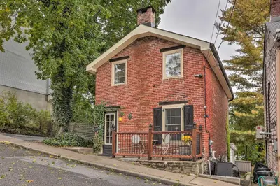 a red brick house with a balcony on a street at Historic Home in Lambertville Walk to Bridge in Lambertville