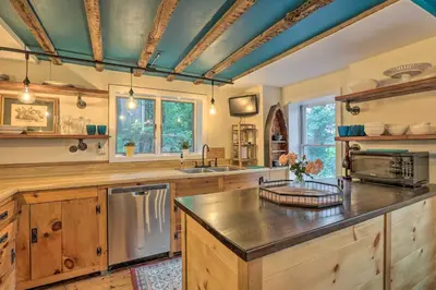 a large kitchen with wooden cabinets and a sink at Historic Home in Lambertville Walk to Bridge in Lambertville