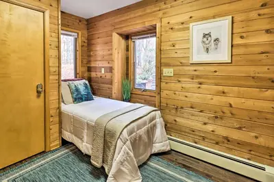 a bedroom with wooden walls and a bed in a room at Outdoor Theater, Deck and Fire Pit Poconos Retreat in Lake Harmony