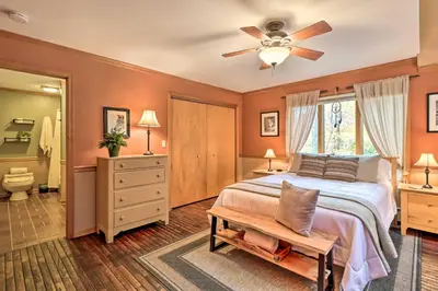 a bedroom with a bed and a ceiling fan at Outdoor Theater, Deck and Fire Pit Poconos Retreat in Lake Harmony