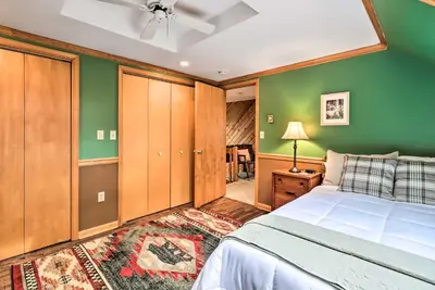 a bedroom with green walls and a white bed at Outdoor Theater, Deck and Fire Pit Poconos Retreat in Lake Harmony