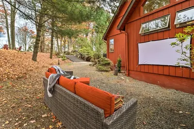 a couch sitting outside of a building with a white screen at Outdoor Theater, Deck and Fire Pit Poconos Retreat in Lake Harmony