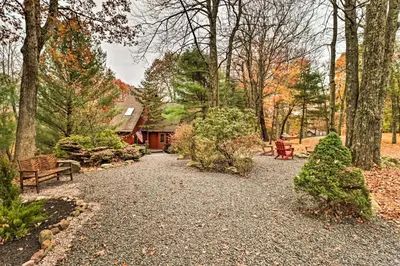 a walkway in a park with benches and trees at Outdoor Theater, Deck and Fire Pit Poconos Retreat in Lake Harmony