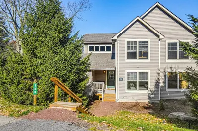 a house with a tree in front of it at Northridge Retreat in Tannersville