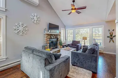 a living room with two couches and a fireplace at Northridge Retreat in Tannersville