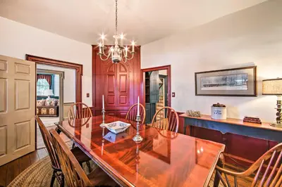 a dining room with a wooden table and chairs at Beautiful Historic House In Amish Country in Ephrata