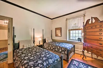 a bedroom with two beds and a dresser at Beautiful Historic House In Amish Country in Ephrata