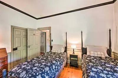 a bedroom with two beds and a dresser at Beautiful Historic House In Amish Country in Ephrata