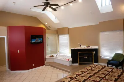 a large living room with a tub and a fireplace at Post Road Inn Motel in Avenel