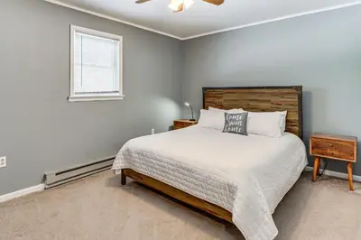 a bedroom with a bed and a window at 4 Mi to Camelback! Group-Friendly Poconos Cabin in Bartonsville