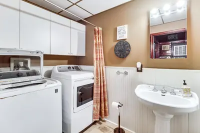 a bathroom with a washing machine and a sink at 4 Mi to Camelback! Group-Friendly Poconos Cabin in Bartonsville
