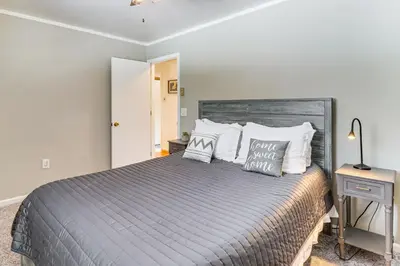 a bedroom with a large bed with white pillows at 4 Mi to Camelback! Group-Friendly Poconos Cabin in Bartonsville