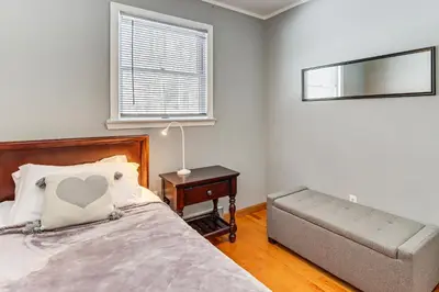a bedroom with a bed and a couch and a window at 4 Mi to Camelback! Group-Friendly Poconos Cabin in Bartonsville