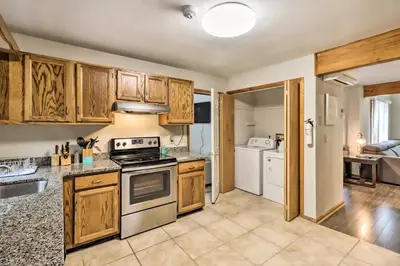 a kitchen with wooden cabinets and a stove top oven at Hot Tub and Game Room Peaceful Poconos Home! in Lake Harmony