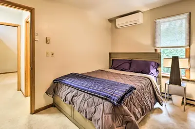 a bedroom with a bed and a window at Hot Tub and Game Room Peaceful Poconos Home! in Lake Harmony