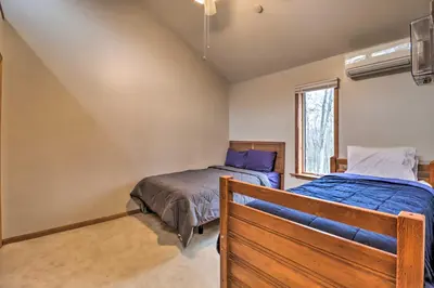 a bedroom with two beds and a window at Hot Tub and Game Room Peaceful Poconos Home! in Lake Harmony