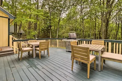 a deck with a table and chairs and a grill at Hot Tub and Game Room Peaceful Poconos Home! in Lake Harmony