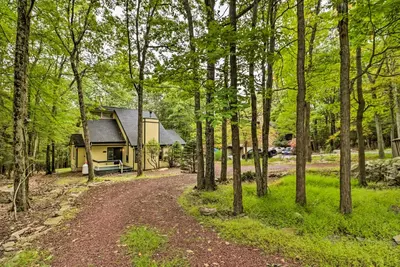 a path leading to a cabin in the woods at Hot Tub and Game Room Peaceful Poconos Home! in Lake Harmony