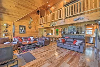 a living room with leather furniture in a cabin at Unadilla Cabin on 50 Acres and Fire Pit and Creek in Unadilla