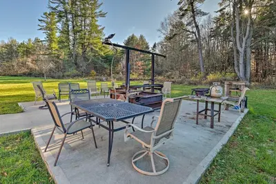 a patio with a table and chairs and a grill at Unadilla Cabin on 50 Acres and Fire Pit and Creek in Unadilla