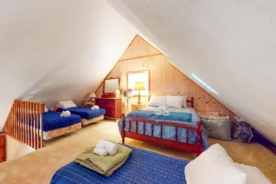 a bedroom with two beds in a attic at Arrowhead Lake Leisure in Pocono Lake