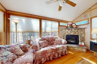 a living room with a couch and a fireplace at Arrowhead Lake Leisure in Pocono Lake
