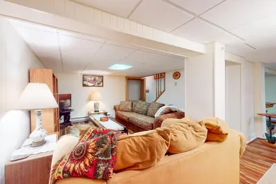 a living room with a couch and a table at Arrowhead Lake Leisure in Pocono Lake