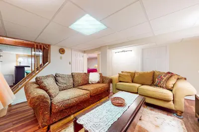 a living room with two couches and a table at Arrowhead Lake Leisure in Pocono Lake