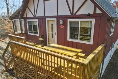 a red tiny house with a wooden deck at Arrowhead Lake Leisure in Pocono Lake
