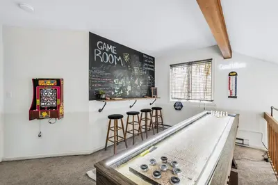 a room with a ping pong table and stools at Welcome to The Mountain Escape! in Albrightsville