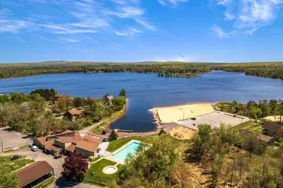 an aerial view of a lake with a tennis court at Welcome to The Mountain Escape! in Albrightsville