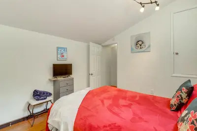 a bedroom with a red and white bed and a television at Community Indoor Pool Tannersville Townhome in Tannersville