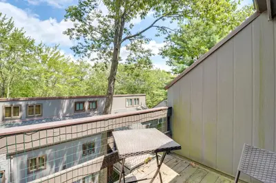 a balcony with a table and a chair at Community Indoor Pool Tannersville Townhome in Tannersville