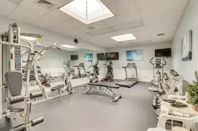 a gym with treadmills and machines in a room at Community Indoor Pool Tannersville Townhome in Tannersville