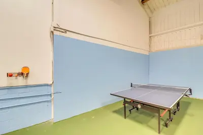 an empty room with a ping pong table in it at Community Indoor Pool Tannersville Townhome in Tannersville