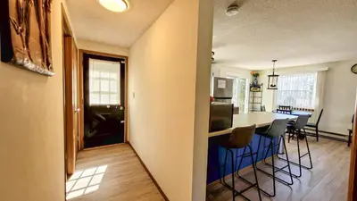 a kitchen and living room with a table and chairs at Pocono House in a private community 4 pools, Lake. in Tobyhanna