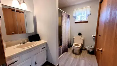a bathroom with a sink and a toilet at Pocono House in a private community 4 pools, Lake. in Tobyhanna