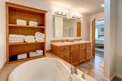 a bathroom with a tub and a sink and a mirror at Bluestone Hill House in Walton