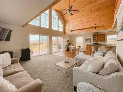 a living room with two couches and a table at Bluestone Hill House in Walton