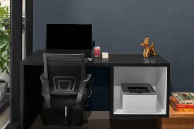 a desk with a computer and a chair and a printer at Aloft New York Chelsea in New York