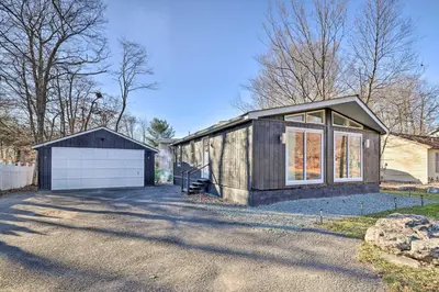 a house with a garage and a building at Game Room! Tobyhanna Retreat 17 Mi to Ski Slopes in Tobyhanna