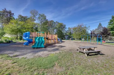 a playground with a blue slide and a bench at Game Room! Tobyhanna Retreat 17 Mi to Ski Slopes in Tobyhanna