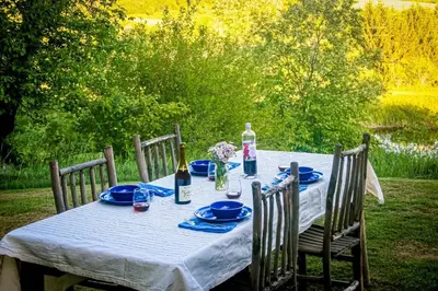 a table with blue plates and wine bottles on it at Hamden Hill House in Hamden