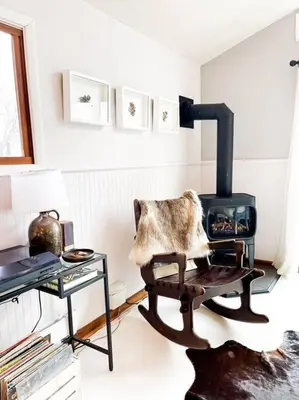 a living room with a chair and a stove at Hamden Hill House in Hamden