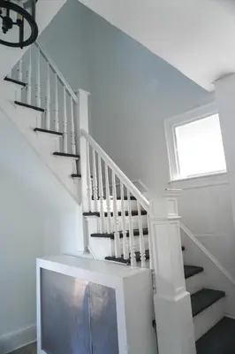 a white staircase with a white railing and a window at Lincoln Manor - Newly Renovated, 1mile from PHL Airport and Sports Stadiums in Prospect Park
